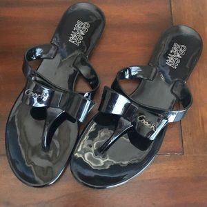Black patent Coach bow flip flops